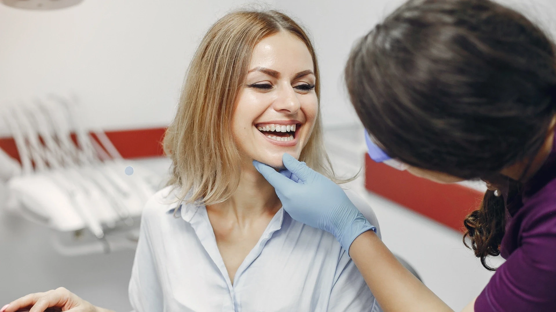 dentist checking patient's teeth after procedure